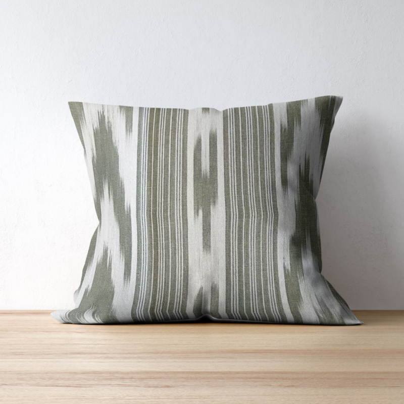 Gorg Blau Olive Green fabric by Teixits Riera on a throw pillow